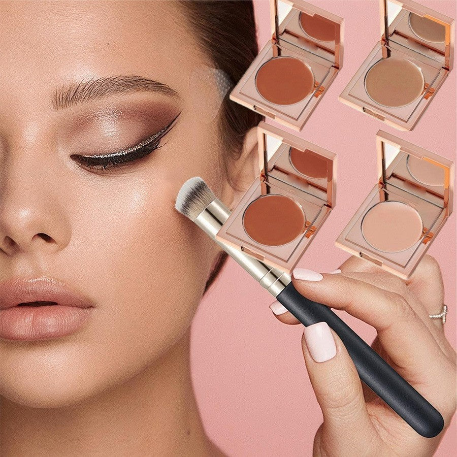 A close-up of a model applying makeup with a brush, alongside four open makeup compacts showing different warm-toned face powders on a soft pink background.